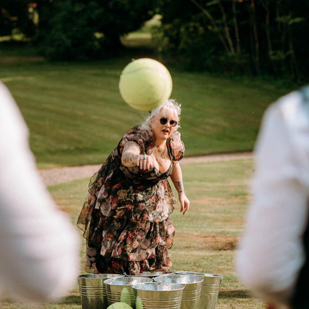 Lady playing Giant Beer Pong at an East Midlands wedding — available as part of our garden games hire packages.
