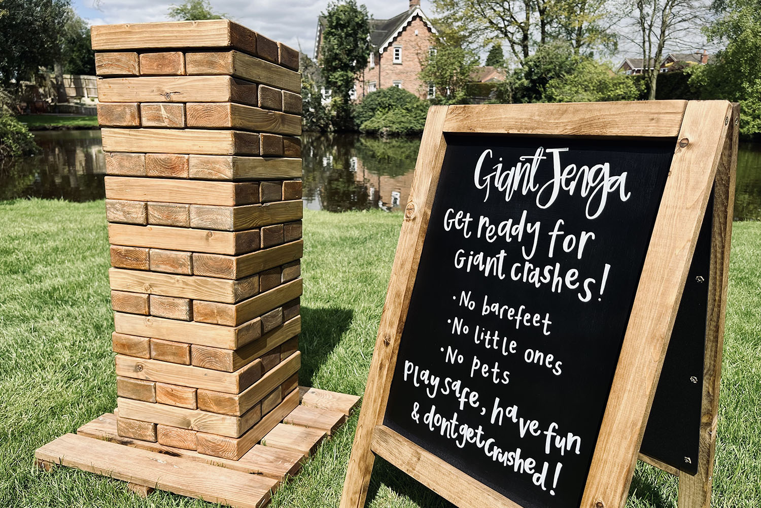 Oversized Giant Jenga blocks stacked in a picturesque garden setting.