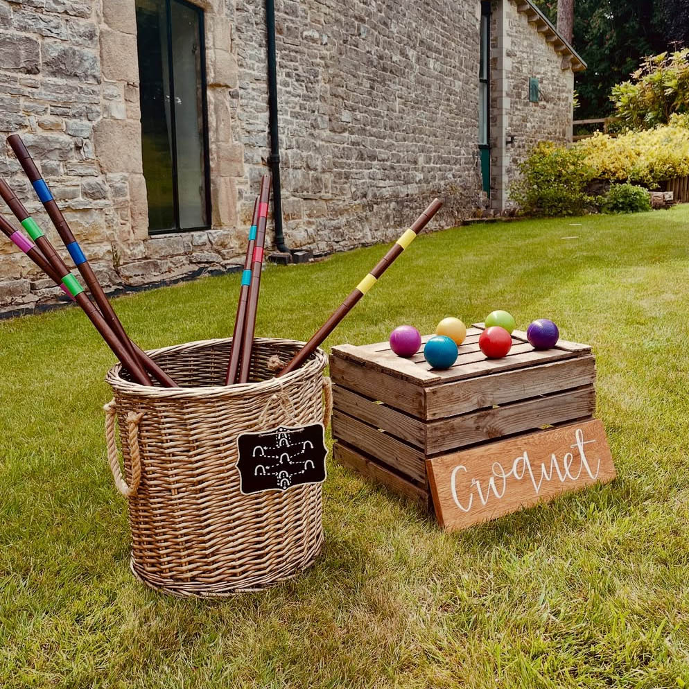 Croquet: Complete vintage wooden croquet set with mallets, balls, and hoops arranged for a manor house wedding.