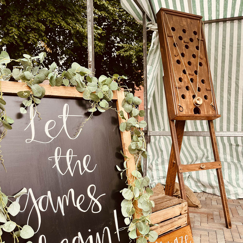 Wall Maze: Vertical wooden Wall Maze game with pulley-controlled marble challenge for interactive guest entertainment.