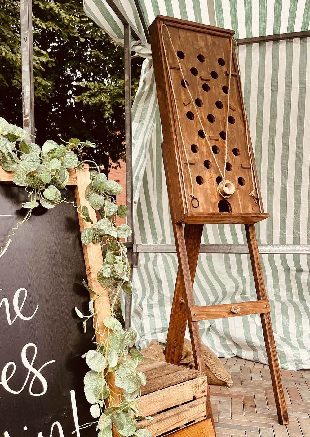 A handcrafted wooden vertical Wall Maze game for event hire by Pop Up Party UK, featuring a marble-run style challenge.